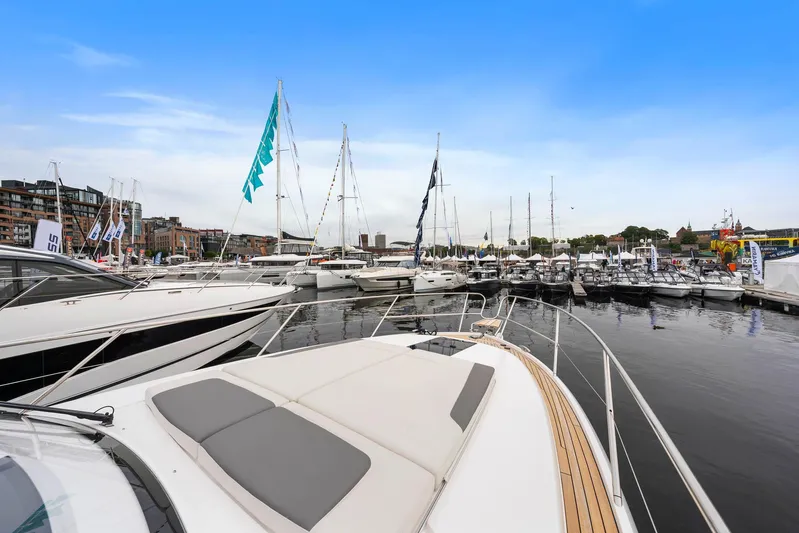 V40157 Yacht Photos Pics Luxury yachts docked at marina, featuring 2023 Princess V40 under clear blue sky.