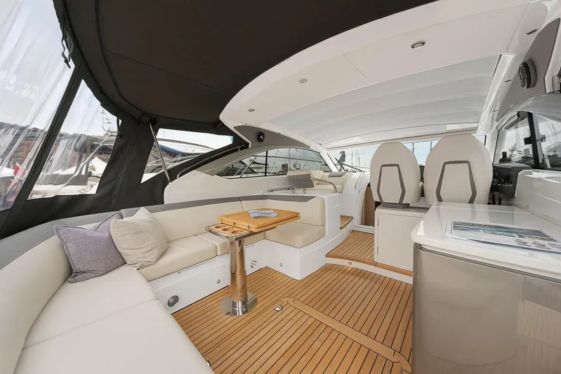 V40157 Yacht Photos Pics Luxurious interior of 2023 Princess V40 yacht with elegant seating and wooden flooring.