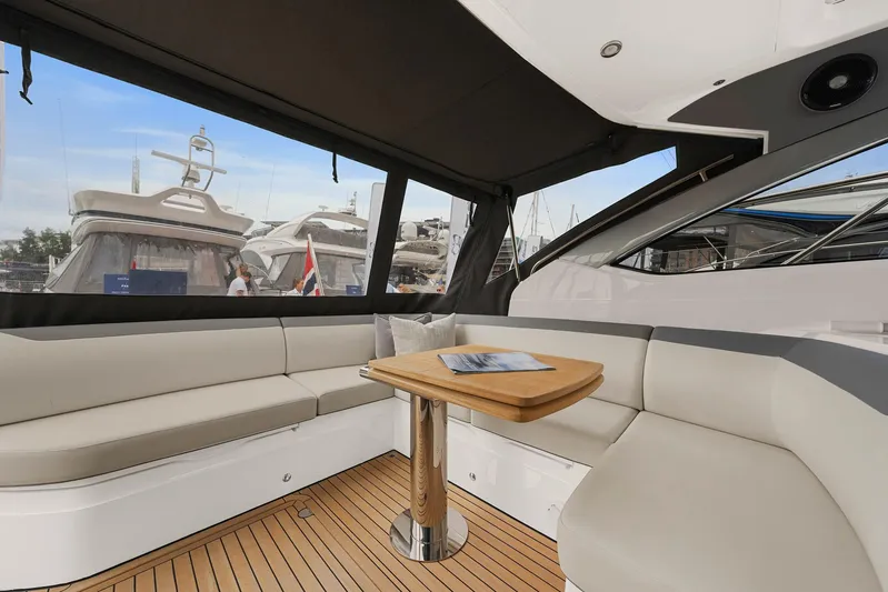 V40157 Yacht Photos Pics Luxurious interior of 2023 Princess V40 yacht with elegant seating and wooden table.