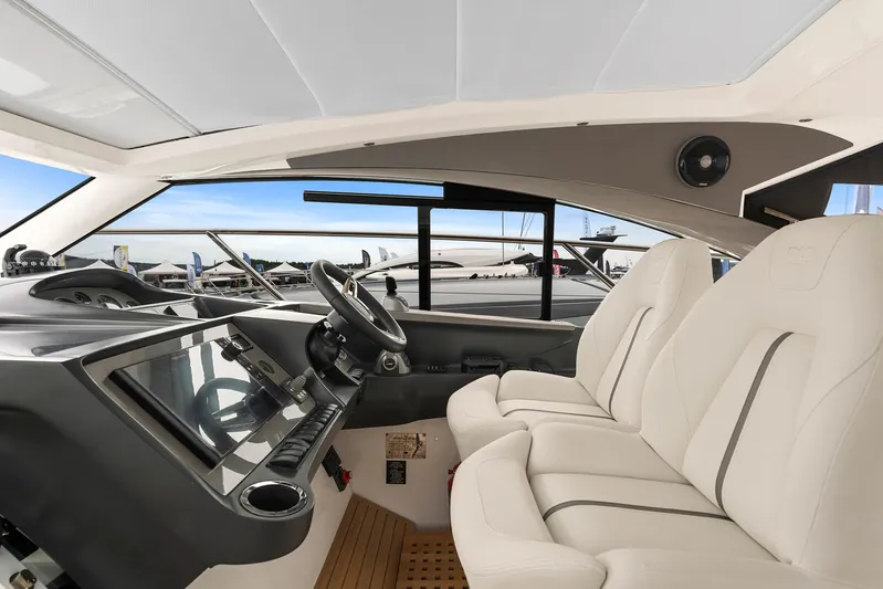 V40157 Yacht Photos Pics Interior of 2023 Princess V40 yacht with modern helm and luxurious seating.