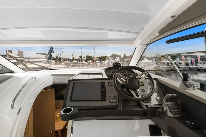 V40157 Yacht Photos Pics 2023 Princess V40 yacht cockpit with modern navigation controls and panoramic marina view.