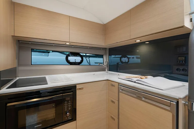 V40157 Yacht Photos Pics Modern kitchen interior in 2023 Princess V40 yacht, featuring sleek cabinetry and appliances.