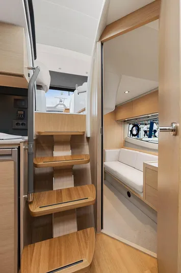 V40157 Yacht Photos Pics Interior of 2023 Princess V40 yacht with wooden stairs and cozy seating area.