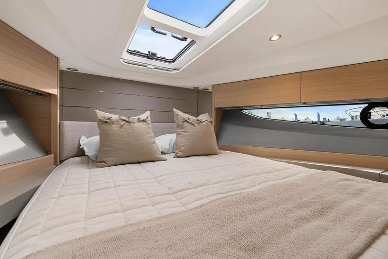 V40157 Yacht Photos Pics Luxurious cabin interior of 2023 Princess V40 yacht with skylight and plush bedding.