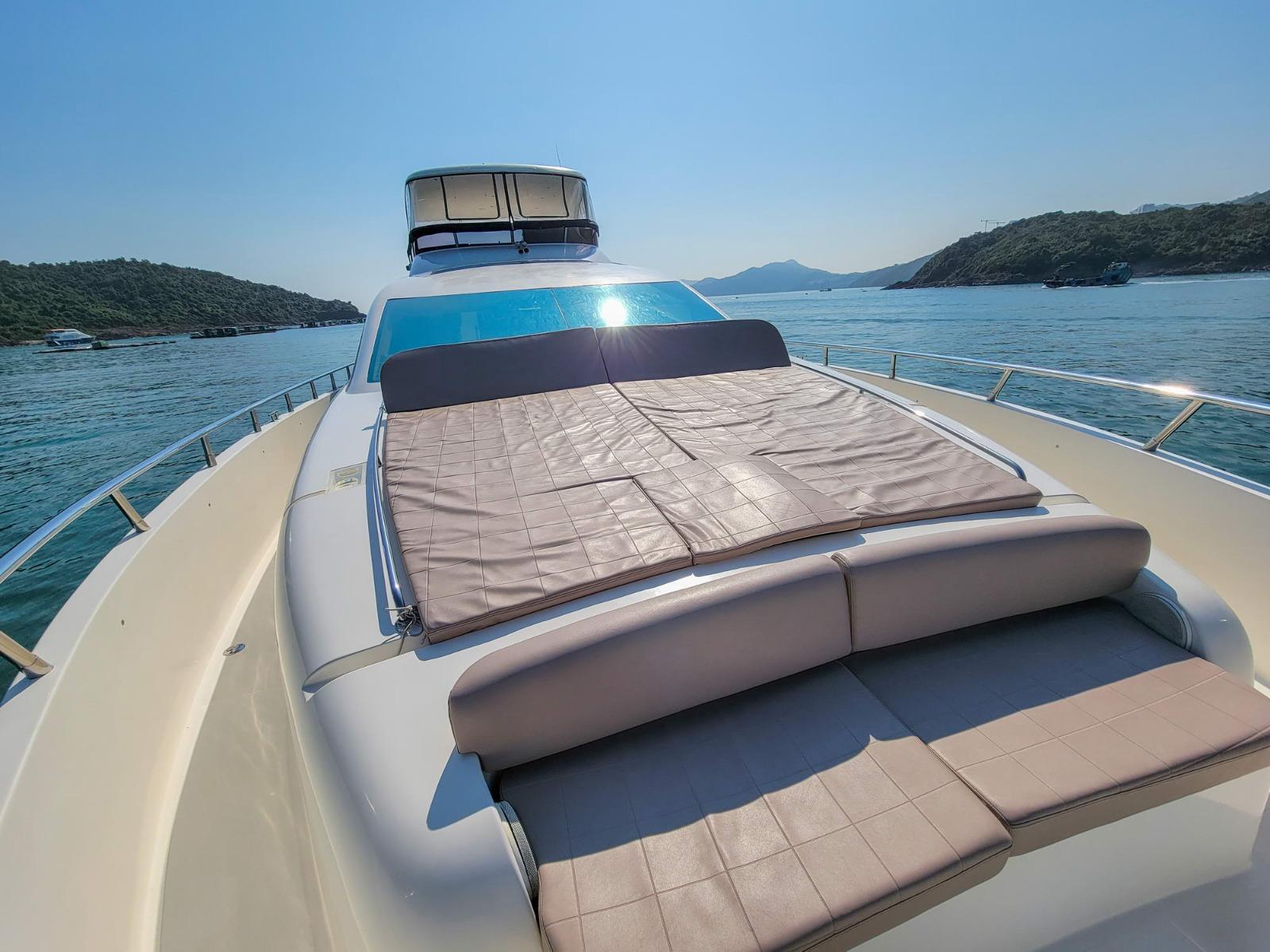 Luxurious 2014 Ruby 80 yacht with sunbathing deck on serene waters.