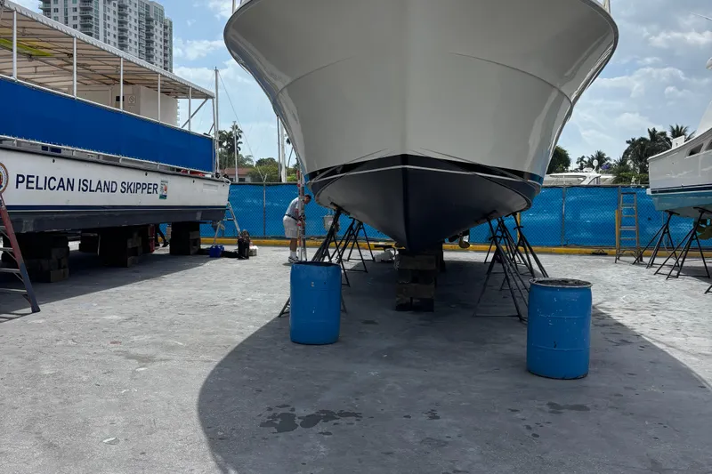  Yacht Photos Pics 1990 Viking 43 Convertible yacht in dry dock, with maintenance equipment nearby.