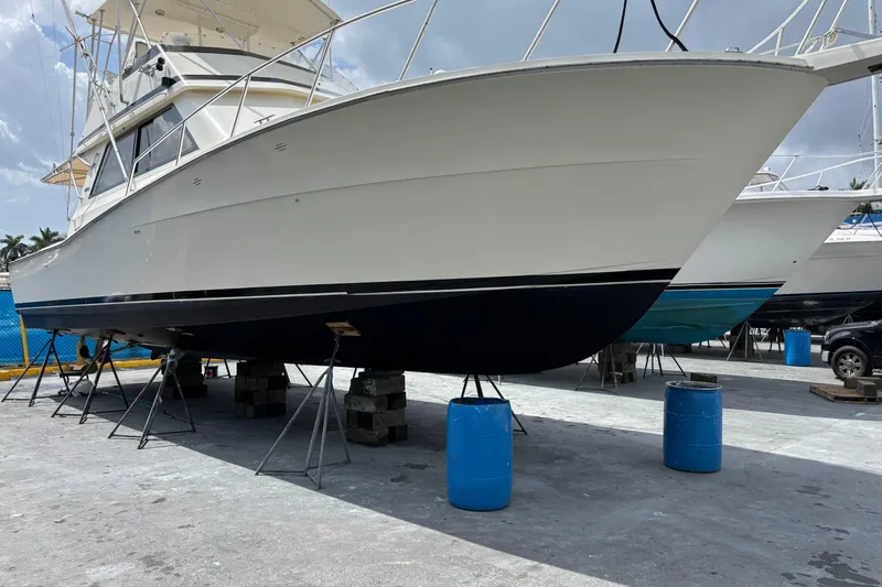  Yacht Photos Pics 1990 Viking 43 Convertible yacht on dry dock, supported by stands and barrels.
