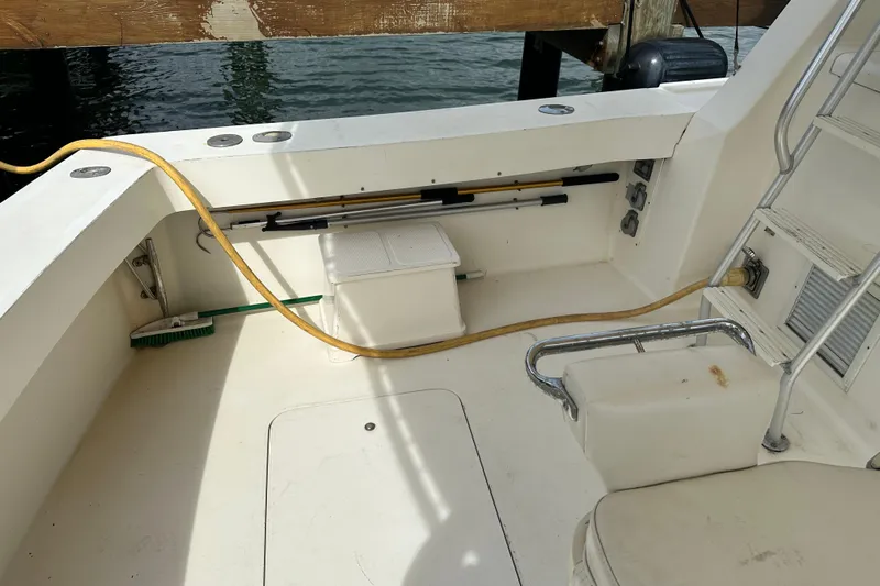  Yacht Photos Pics 1990 Viking 43 Convertible boat deck with seating, storage, and cleaning tools.