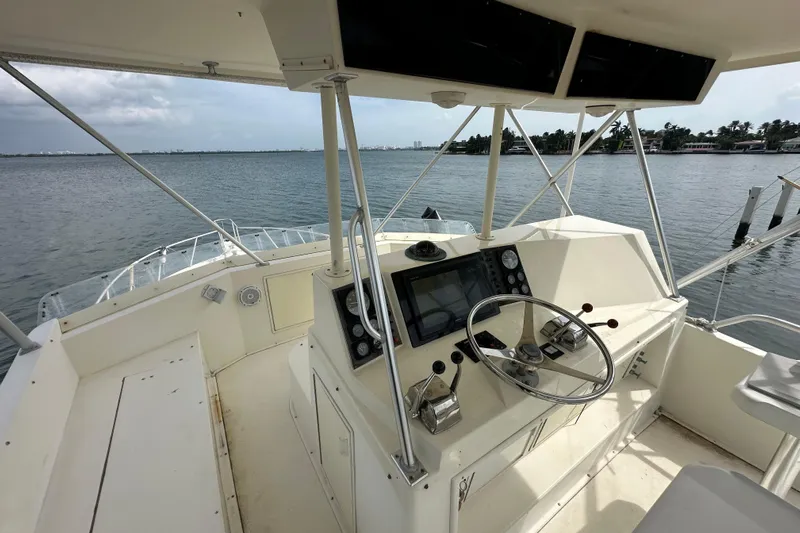 Yacht Photos Pics Cockpit of 1990 Viking 43 Convertible yacht with steering wheel and navigation controls.