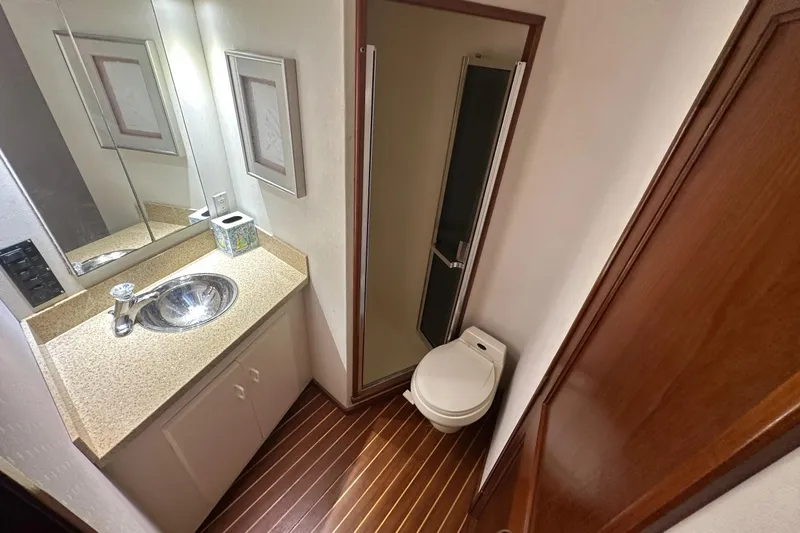  Yacht Photos Pics Bathroom interior of 1990 Viking 43 Convertible yacht with sink, toilet, and shower.