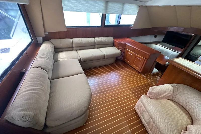  Yacht Photos Pics Luxurious interior of a 1990 Viking 43 Convertible yacht with plush seating and wooden flooring.