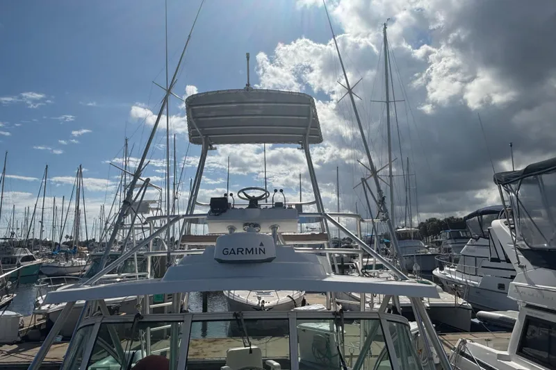 Distraction Yacht Photos Pics 2004 Luhrs 32 Open boat docked at marina under cloudy sky.
