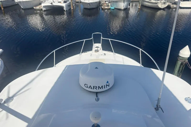 Distraction Yacht Photos Pics 2004 Luhrs 32 Open boat with Garmin equipment, docked in a marina.