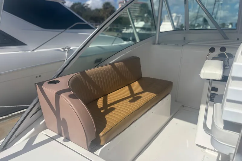 Distraction Yacht Photos Pics 2004 Luhrs 32 Open boat interior with tan seating and control panel.