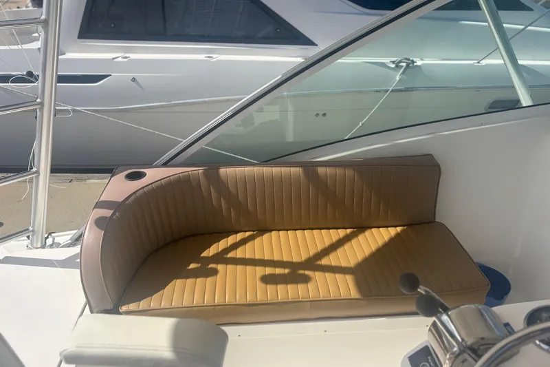 Distraction Yacht Photos Pics 2004 Luhrs 32 Open boat interior with tan cushioned seating and steering controls.
