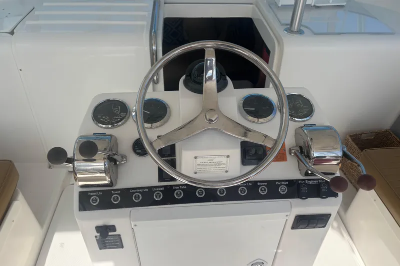 Distraction Yacht Photos Pics 2004 Luhrs 32 Open helm with steering wheel, gauges, and controls.