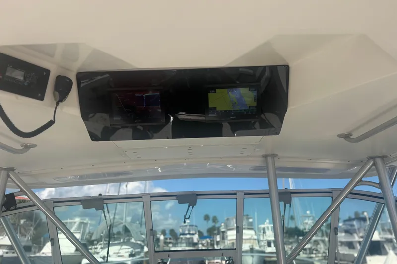 Distraction Yacht Photos Pics 2004 Luhrs 32 Open boat cockpit with navigation equipment and marina view.