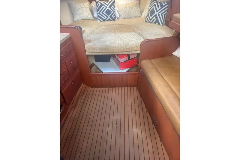 Distraction Yacht Photos Pics 2004 Luhrs 32 Open cabin interior with cushioned seating and wooden flooring.