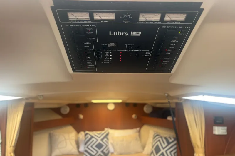 Distraction Yacht Photos Pics Control panel of a 2004 Luhrs 32 Open boat interior, with cozy cabin and pillows.