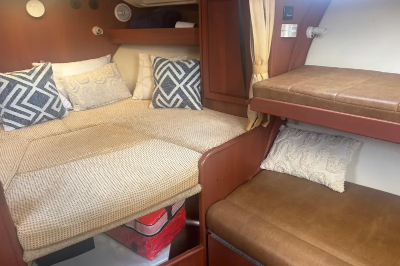 Distraction Yacht Photos Pics 2004 Luhrs 32 Open cabin interior with cozy bedding and decorative pillows.