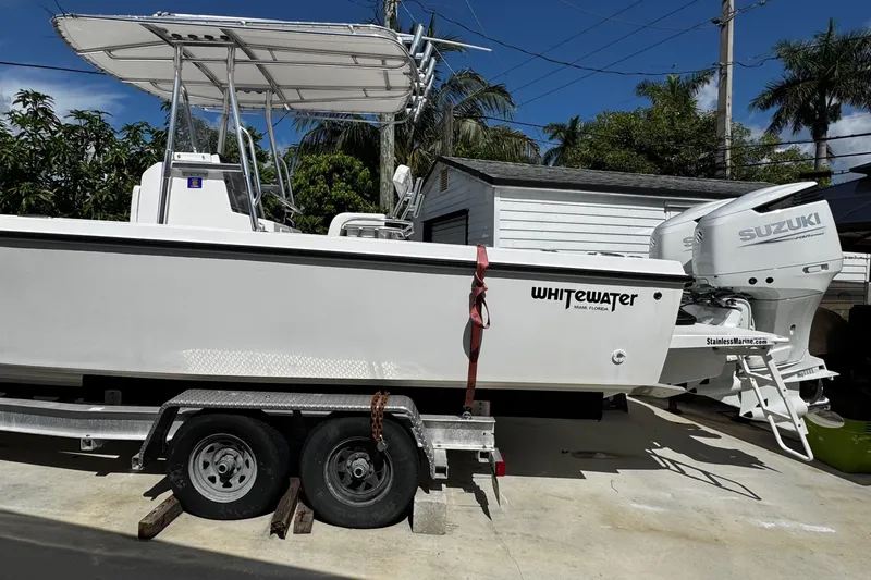  Yacht Photos Pics 2022 Whitewater 28 Open boat on trailer with Suzuki outboard motor.