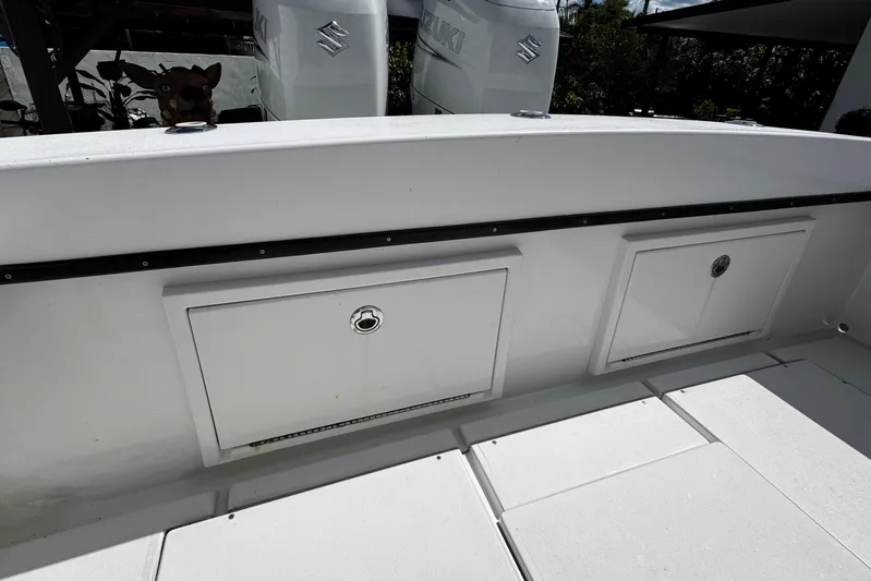  Yacht Photos Pics 2022 Whitewater 28 Open boat deck with storage compartments and Suzuki engines.