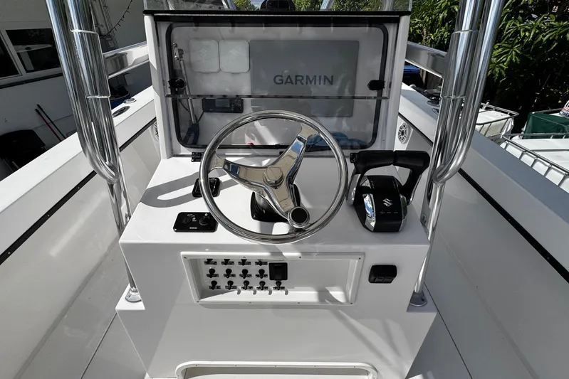  Yacht Photos Pics 2022 Whitewater 28 Open boat console with Garmin navigation and steering wheel.