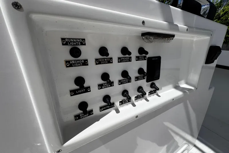  Yacht Photos Pics Control panel of 2022 Whitewater 28 Open boat with labeled switches.
