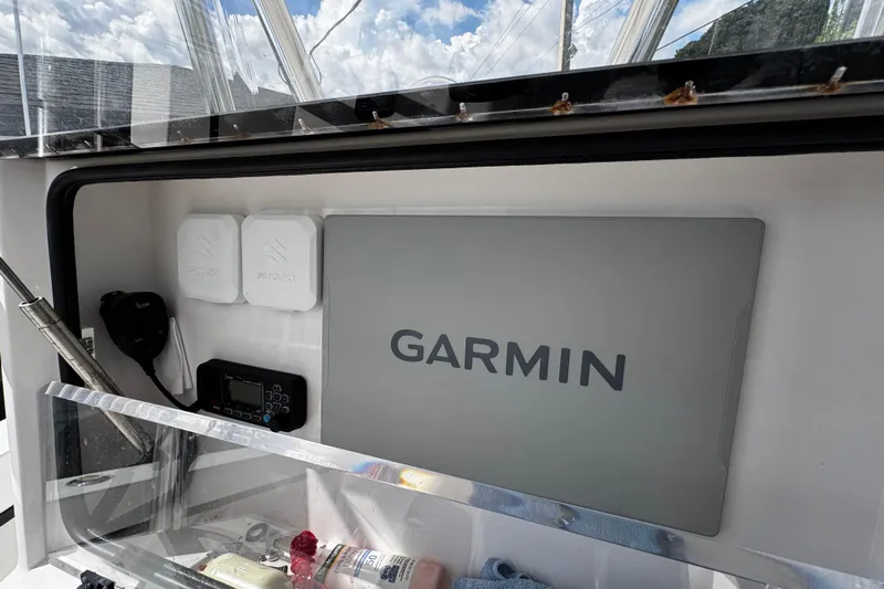  Yacht Photos Pics 2022 Whitewater 28 Open boat dashboard with Garmin navigation system and Suzuki components.