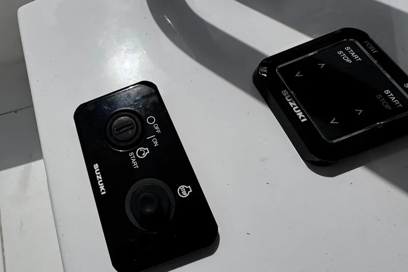  Yacht Photos Pics Control panel of a 2022 Whitewater 28 Open boat with Suzuki start-stop buttons.