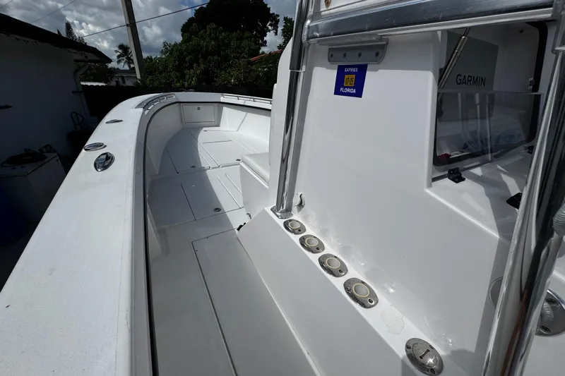  Yacht Photos Pics 2022 Whitewater 28 Open boat interior with Garmin equipment, docked in Florida.