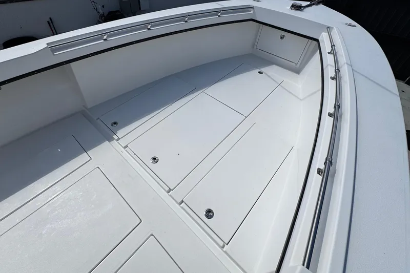  Yacht Photos Pics 2022 Whitewater 28 Open boat deck with storage compartments and stainless steel railing.
