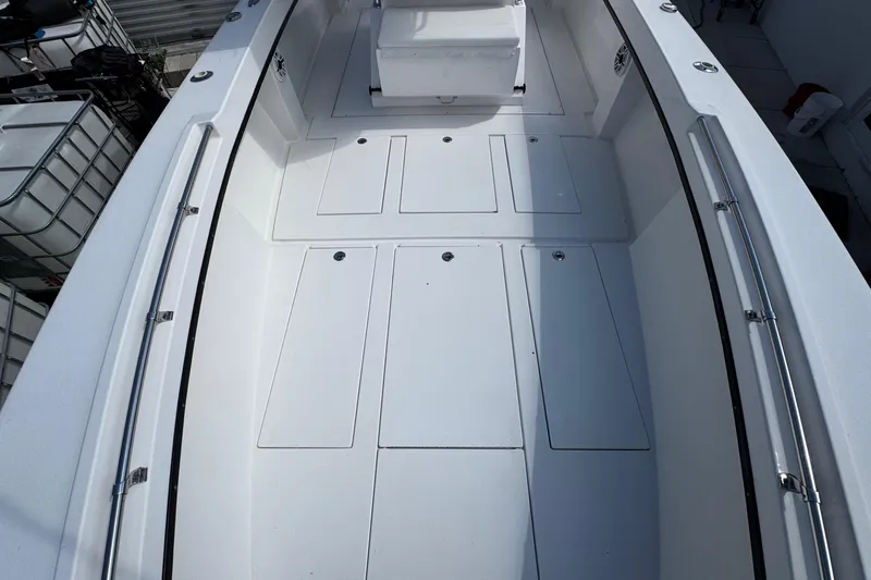  Yacht Photos Pics 2022 Whitewater 28 Open boat interior with spacious deck and storage compartments.