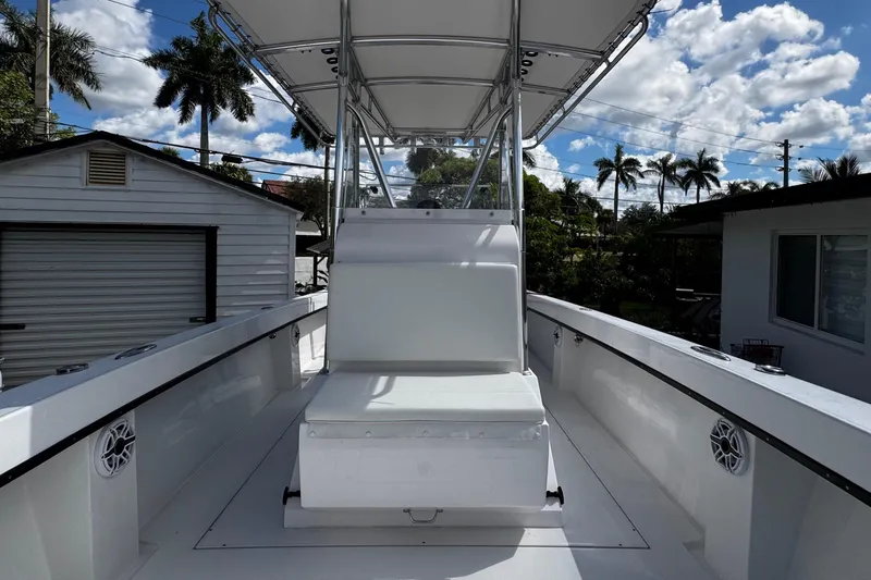  Yacht Photos Pics 2022 Whitewater 28 Open boat with seating, under a clear blue sky.
