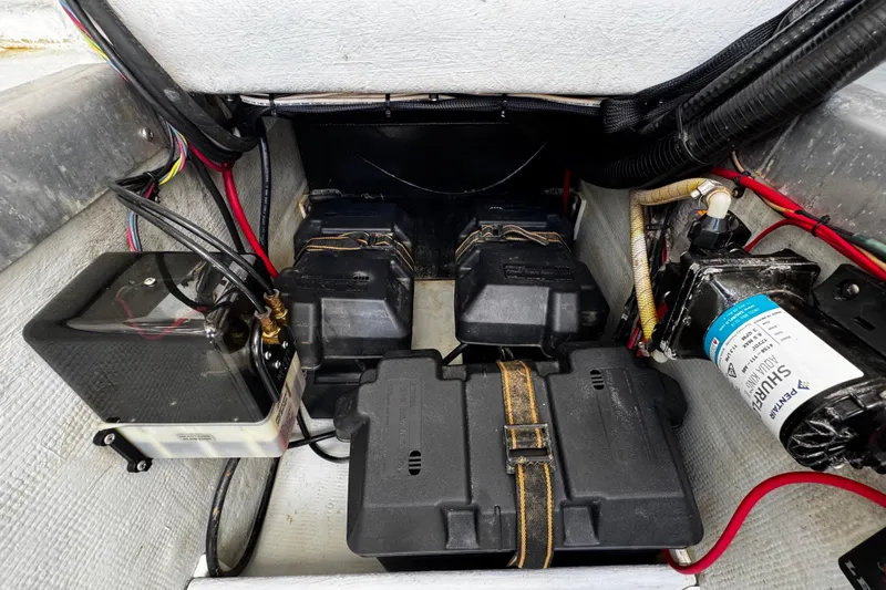  Yacht Photos Pics 2022 Whitewater 28 Open boat battery compartment with wiring and components.
