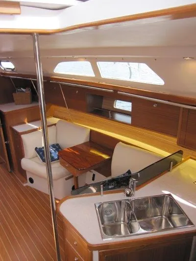 Hurkle Durkle Yacht Photos Pics Interior of 2024 Catalina 385 sailboat with modern kitchen and cozy seating area.