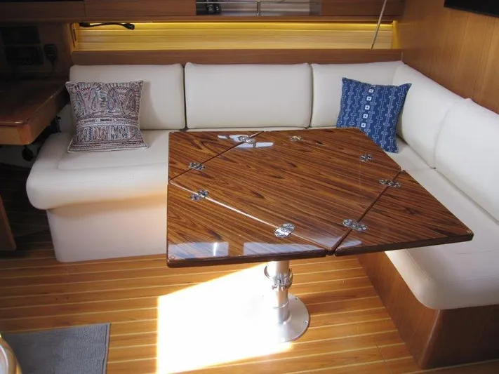 Hurkle Durkle Yacht Photos Pics Luxurious Catalina 385 yacht interior with elegant wood table and plush seating, 2024 model.
