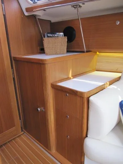 Hurkle Durkle Yacht Photos Pics 2024 Catalina 385 yacht interior with wooden cabinetry and white seating.
