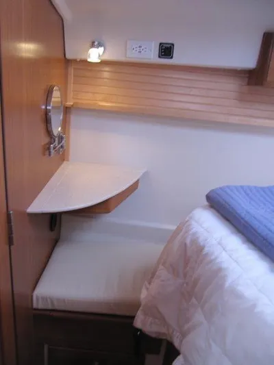 Hurkle Durkle Yacht Photos Pics 2024 Catalina 385 yacht interior with cozy bed and wooden accents.