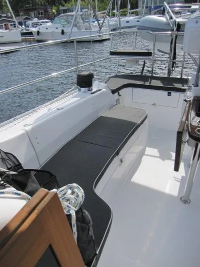 Hurkle Durkle Yacht Photos Pics 2024 Catalina 385 sailboat cockpit with seating, docked in a marina.