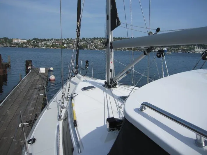 Hurkle Durkle Yacht Photos Pics 2024 Catalina 385 sailboat docked by a scenic waterfront.