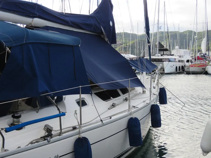  Yacht Photos Pics Jeanneau Sun Odyssey 40 sailboat, 2000 model, docked in a marina with blue covers.