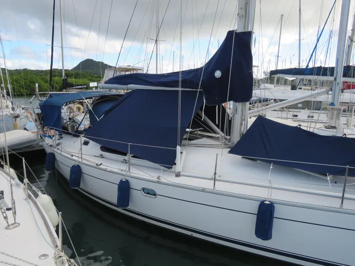  Yacht Photos Pics Jeanneau Sun Odyssey 40 sailboat, 2000 model, docked with blue covers and fenders.