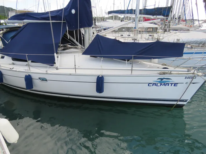  Yacht Photos Pics Jeanneau Sun Odyssey 40 sailboat, 2000 model, docked with blue covers and fenders.