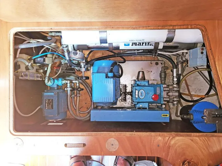  Yacht Photos Pics Engine compartment of 2000 Jeanneau Sun Odyssey 40 sailboat, showcasing mechanical components and wiring.