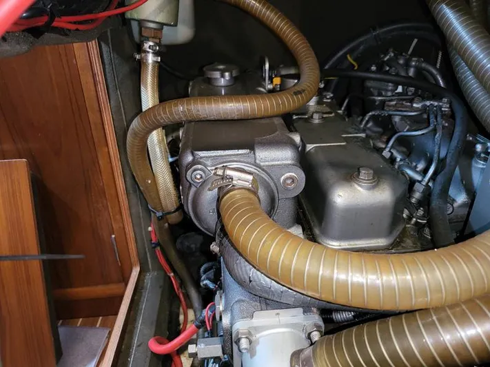  Yacht Photos Pics Engine compartment of a 2000 Jeanneau Sun Odyssey 40 sailboat, showing hoses and components.