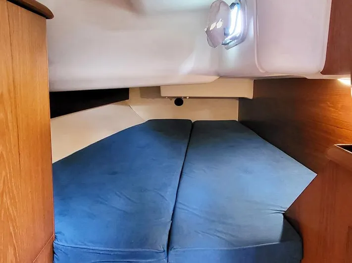  Yacht Photos Pics Cozy cabin interior of 2000 Jeanneau Sun Odyssey 40 sailboat with blue cushions.
