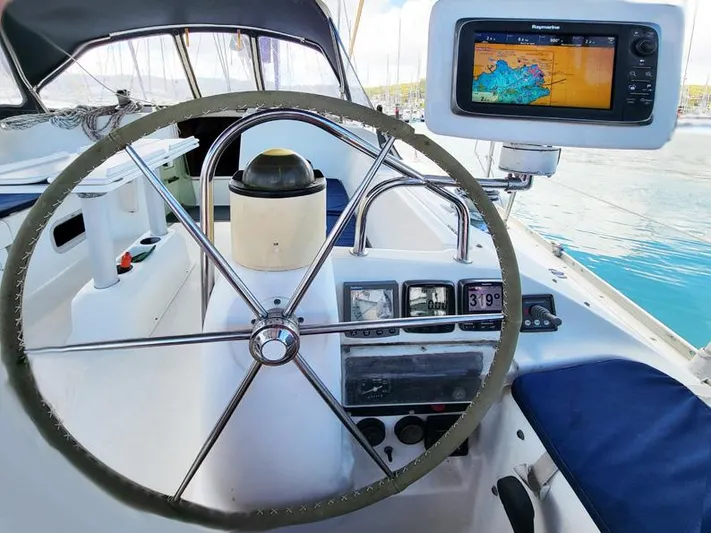  Yacht Photos Pics Cockpit of 2000 Jeanneau Sun Odyssey 40 sailboat with navigation equipment and steering wheel.