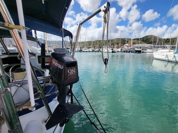  Yacht Photos Pics Jeanneau Sun Odyssey 40 sailboat in marina, featuring Tohatsu outboard motor, clear blue water.