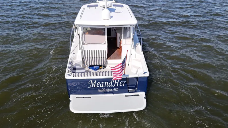  Yacht Photos Pics 2013 Back Cove 34 boat on water, rear view with American flag.